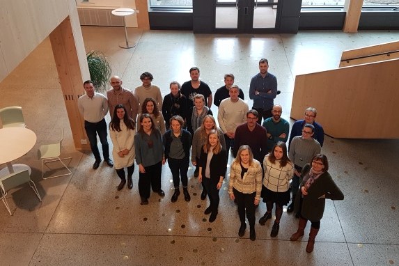 Photo showing the members of the PerForm group at a meeting in Uppsala, standing in an aula, photographed from above.